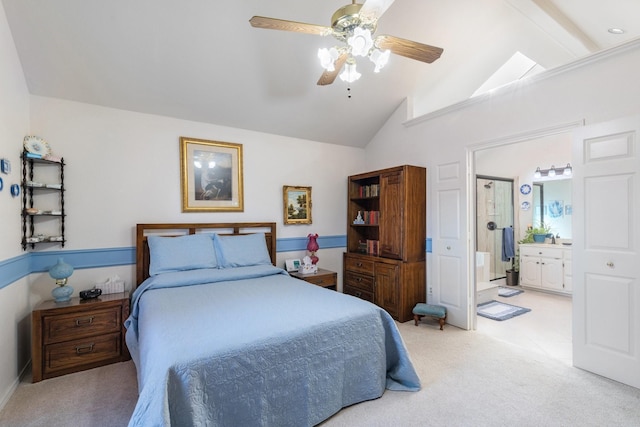 carpeted bedroom featuring vaulted ceiling, ensuite bath, and ceiling fan