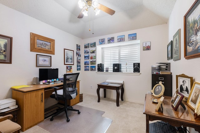 home office featuring ceiling fan, light carpet, and vaulted ceiling