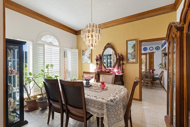 tiled dining space featuring crown molding, a textured ceiling, and a chandelier