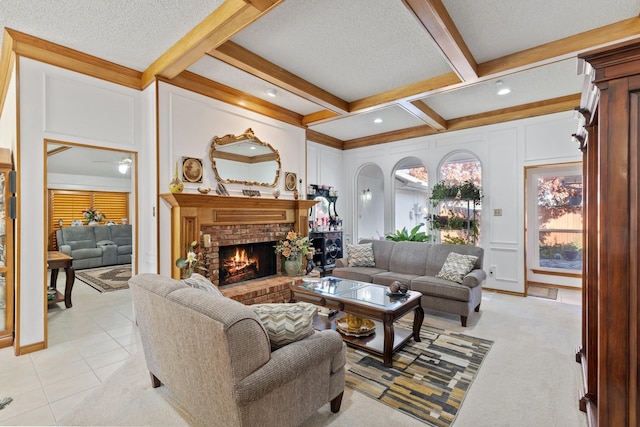 living room featuring beam ceiling, coffered ceiling, a brick fireplace, a textured ceiling, and light tile patterned floors