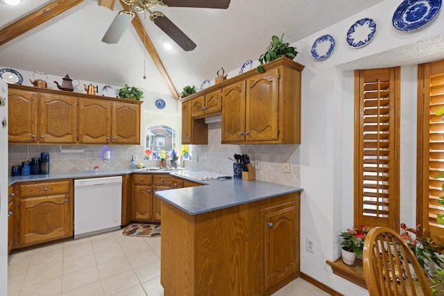 kitchen featuring dishwasher, vaulted ceiling with beams, light tile patterned floors, a textured ceiling, and kitchen peninsula