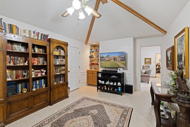 interior space featuring vaulted ceiling with beams, ceiling fan, and light tile patterned floors