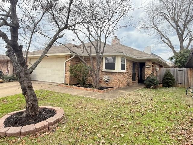 single story home with a garage and a front yard