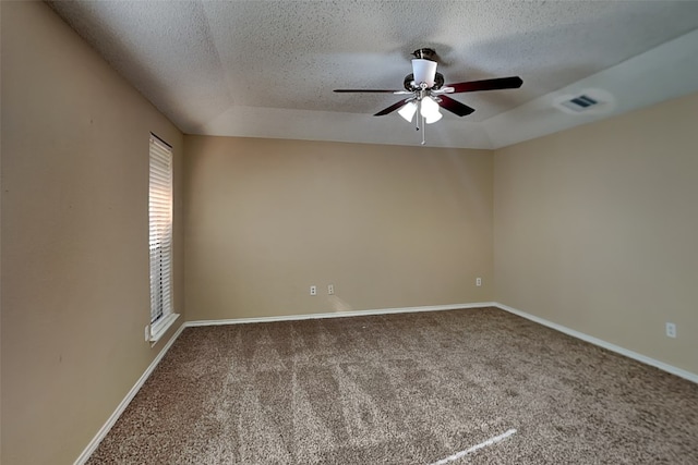 carpeted spare room featuring ceiling fan, a textured ceiling, and a raised ceiling