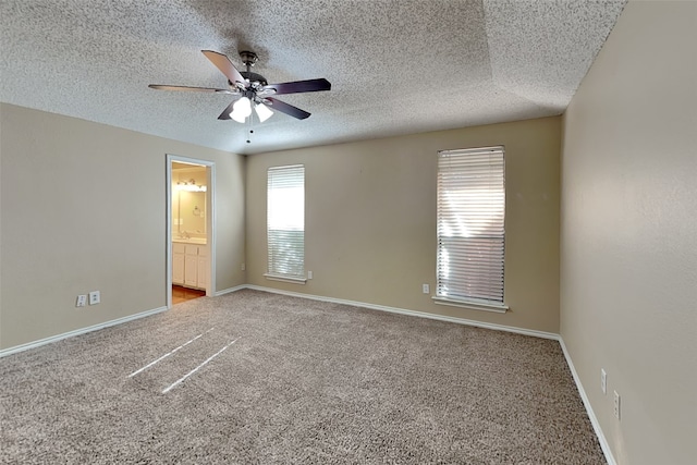 carpeted spare room with ceiling fan and a textured ceiling