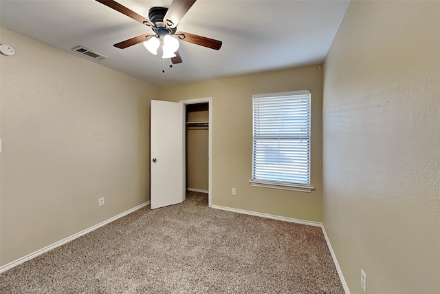 unfurnished bedroom featuring light colored carpet, a closet, and ceiling fan