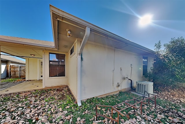 view of side of property featuring central AC