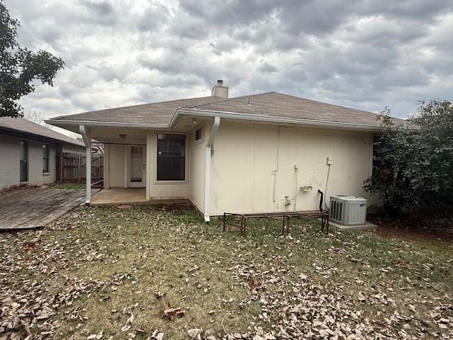 back of property featuring a patio area, central AC unit, and a lawn