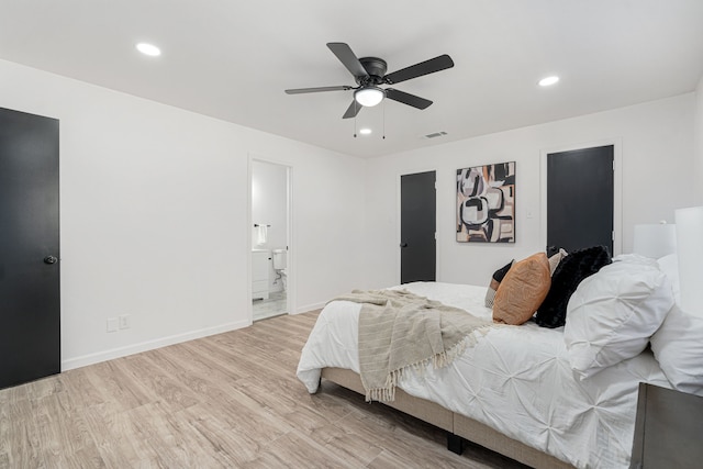 bedroom with ensuite bathroom, ceiling fan, and light hardwood / wood-style floors