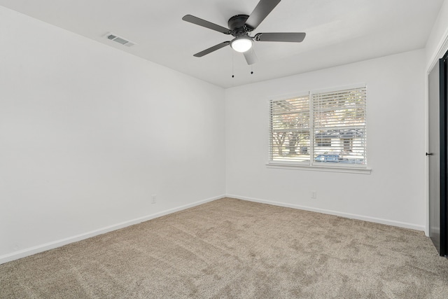 empty room featuring light carpet and ceiling fan