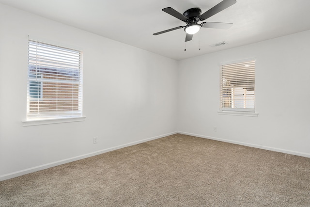 carpeted empty room with plenty of natural light and ceiling fan