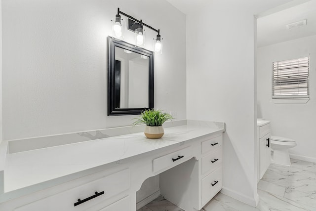 bathroom featuring vanity and toilet