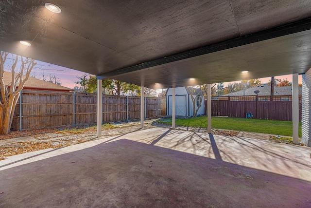 patio terrace at dusk with a yard and a shed