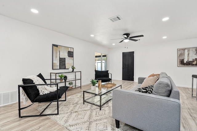 living room featuring ceiling fan and light wood-type flooring