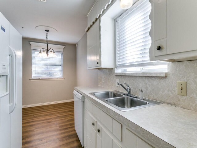 kitchen featuring white cabinets, hanging light fixtures, white appliances, and a chandelier