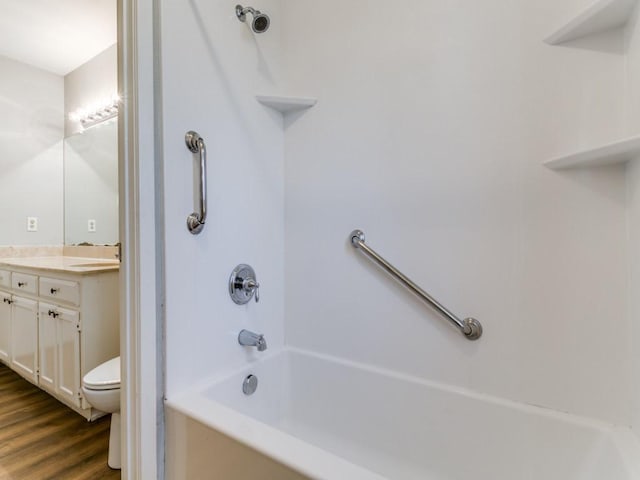 full bathroom with toilet, shower / bathtub combination, wood-type flooring, and vanity