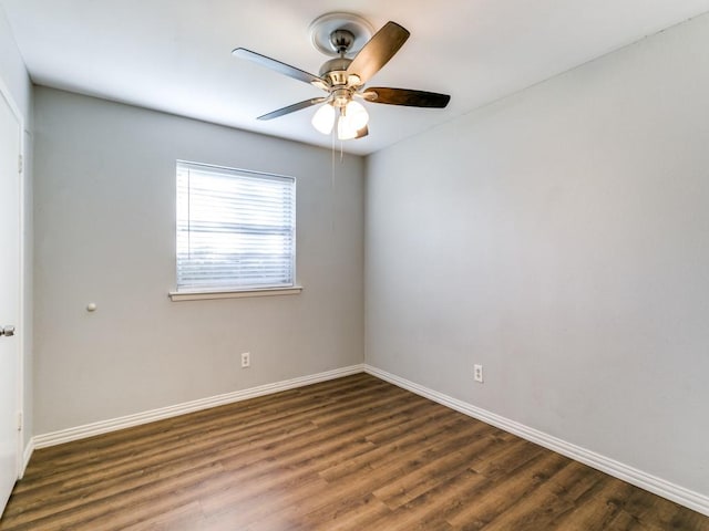 unfurnished room with ceiling fan and dark wood-type flooring