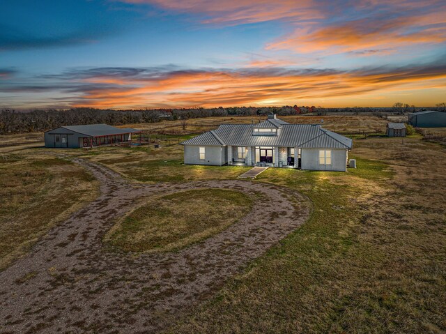 gate at dusk featuring a rural view