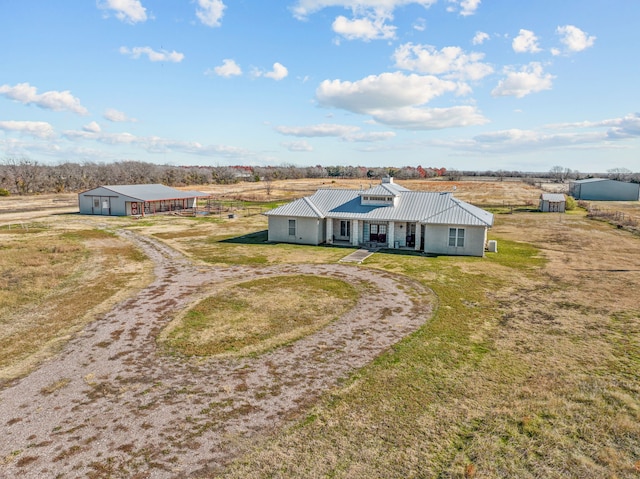 single story home with an outbuilding and a front yard