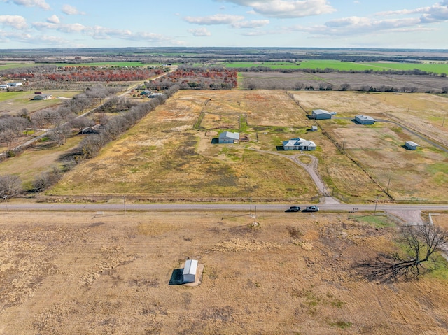 birds eye view of property with a rural view