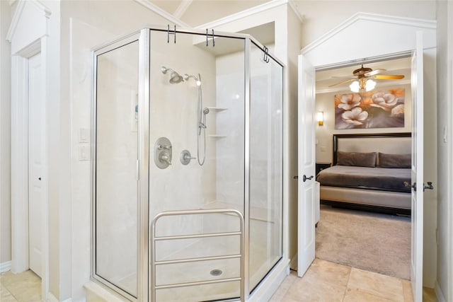 bathroom featuring tile patterned floors, ceiling fan, an enclosed shower, and ornamental molding