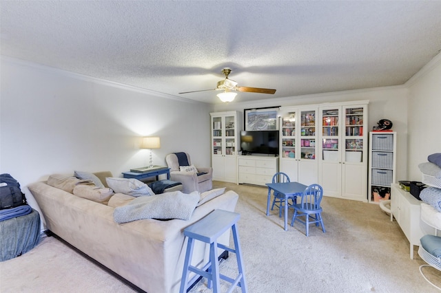 carpeted living room with crown molding, ceiling fan, and a textured ceiling