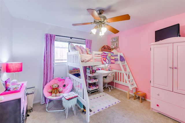 carpeted bedroom with a nursery area and ceiling fan