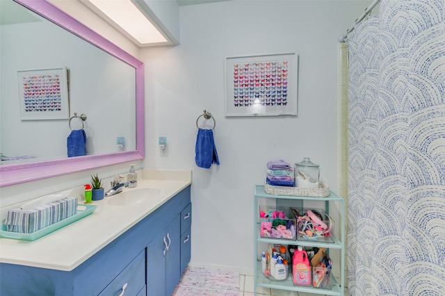 bathroom with curtained shower, tile patterned flooring, and vanity