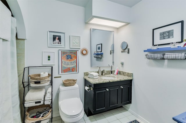 bathroom with tile patterned flooring, vanity, and toilet