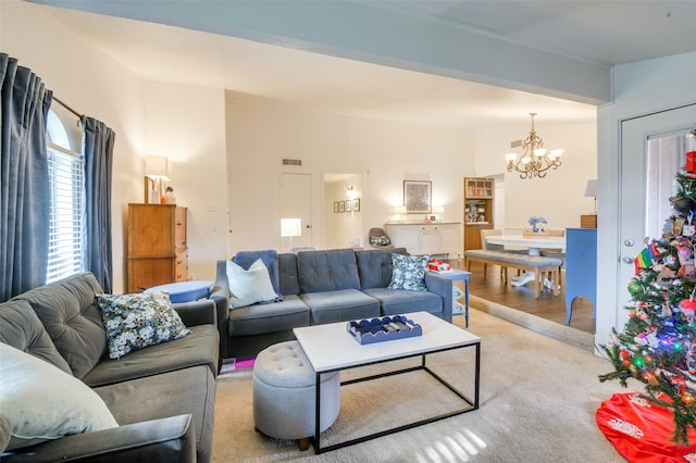 living room featuring a chandelier and light colored carpet