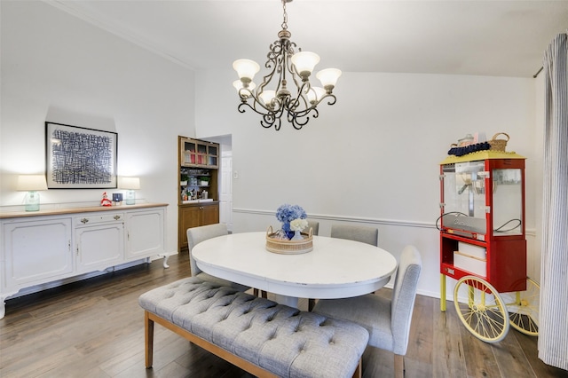 dining room with dark hardwood / wood-style flooring and an inviting chandelier