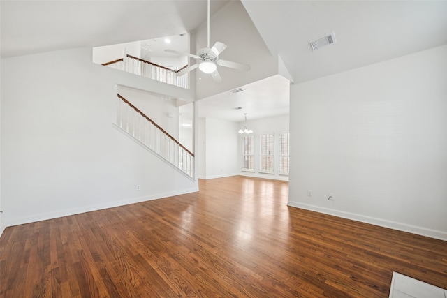 unfurnished living room featuring ceiling fan with notable chandelier, high vaulted ceiling, and hardwood / wood-style flooring