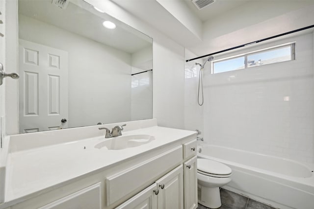 full bathroom featuring tiled shower / bath combo, vanity, tile patterned flooring, and toilet