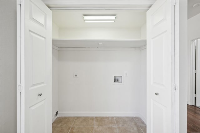 washroom with hookup for a washing machine and light tile patterned flooring