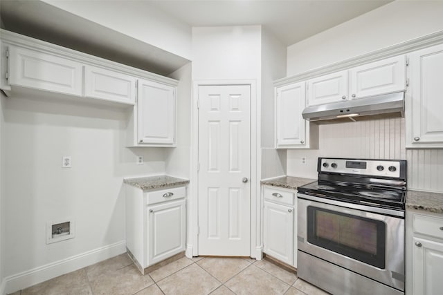 kitchen featuring white cabinetry, light tile patterned floors, dark stone countertops, and stainless steel electric range oven