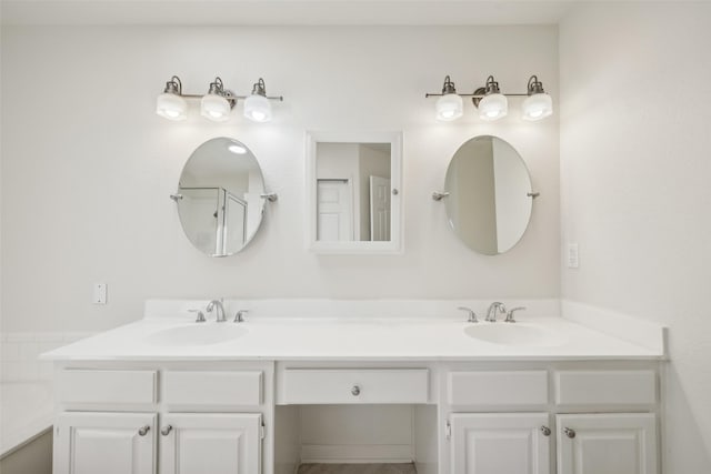 bathroom with vanity and a shower