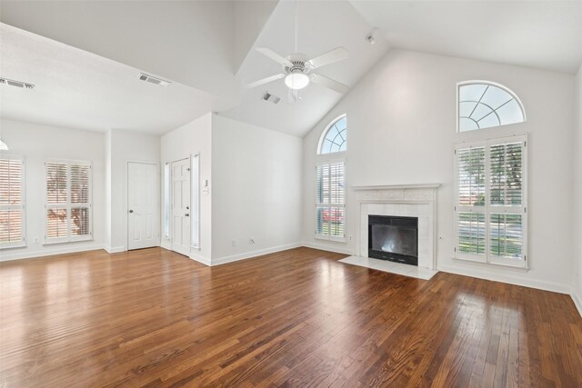 unfurnished living room featuring ceiling fan, a fireplace, high vaulted ceiling, and hardwood / wood-style flooring