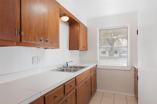 kitchen with plenty of natural light, light tile patterned flooring, and sink