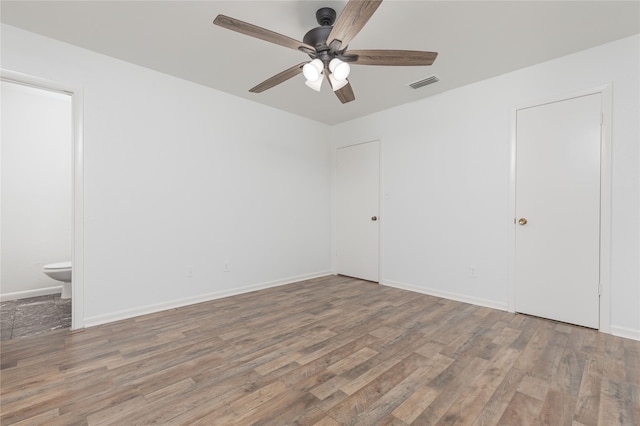 empty room with ceiling fan and wood-type flooring