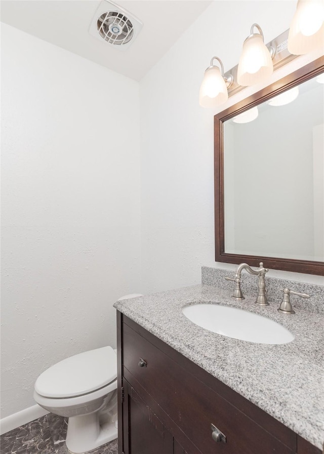 bathroom featuring vanity and toilet