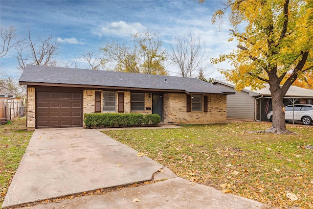 ranch-style home featuring a garage and a front lawn