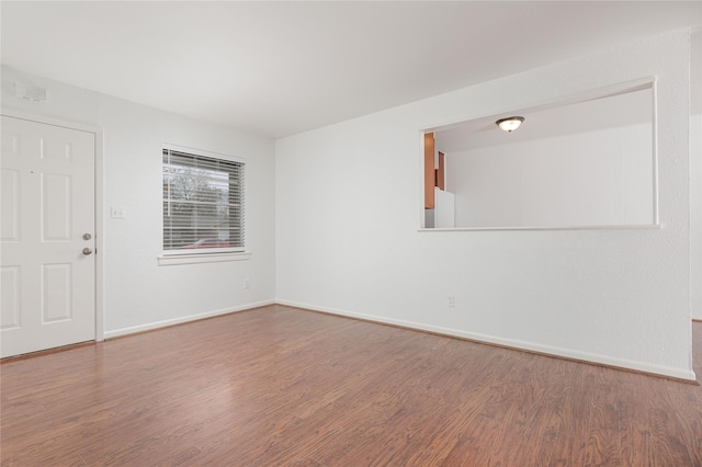 unfurnished room with hardwood / wood-style floors