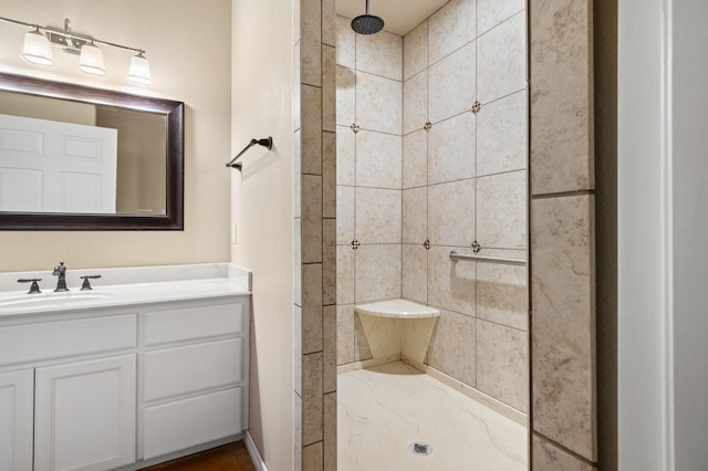 bathroom with vanity and tiled shower