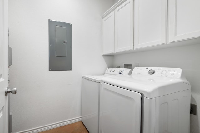 clothes washing area featuring cabinets, separate washer and dryer, and electric panel