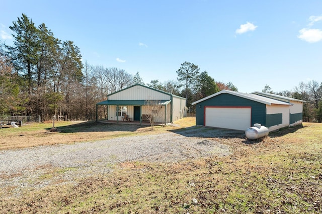 ranch-style home with covered porch and a garage