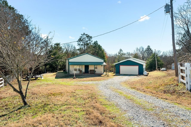 view of front facade with a garage, covered porch, and an outdoor structure