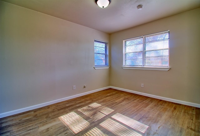 unfurnished room featuring hardwood / wood-style flooring