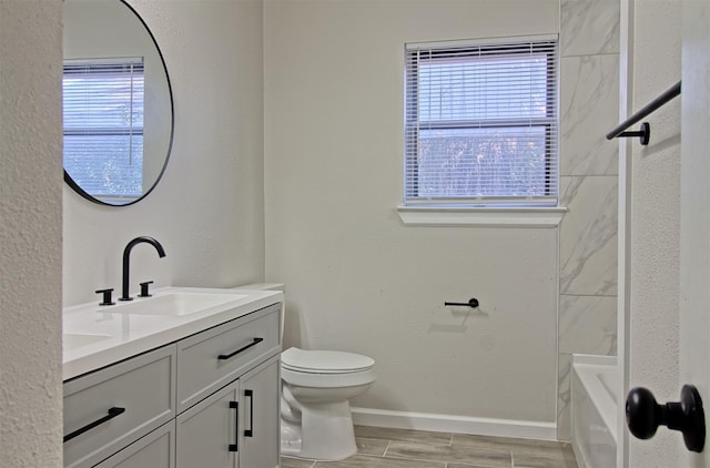 full bathroom with vanity, shower / tub combination, toilet, and a healthy amount of sunlight