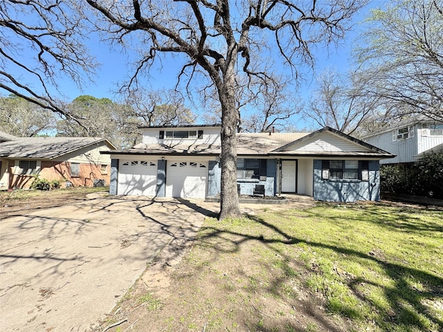traditional home with an attached garage, driveway, and a front lawn