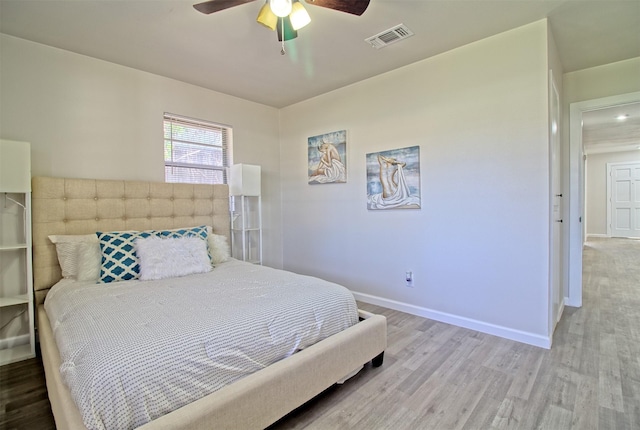 bedroom with light hardwood / wood-style flooring and ceiling fan